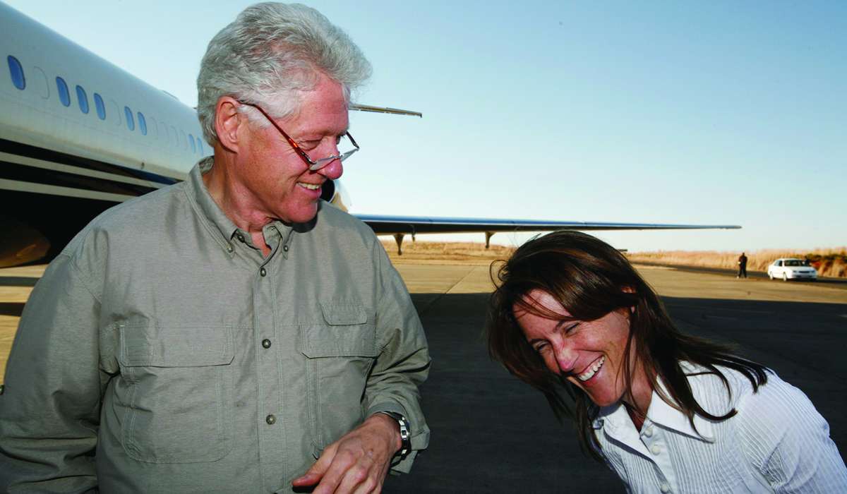 Former President Bill Clinton and Whitney Williams ’94 share a laugh on a trip to South Africa. “She’s one of those rare people who is always doing the right thing in her unique way, with passion, creativity, and good humor,” Clinton says. (Photo by Ralph Alswang)